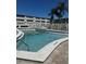 Community outdoor pool features sparkling water, lounge chairs, shade trees, and a secure fenced-in area for residents' relaxation at 8100 Dr Martin Luther King Jr N St # 302, St Petersburg, FL 33702
