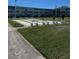 Outdoor shuffleboard courts feature benches and lush grassy area adjacent to a multi-story condominium complex at 8100 Dr Martin Luther King Jr N St # 302, St Petersburg, FL 33702