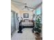 Bright sunroom with tile floors, a daybed, exercise equipment, and a ceiling fan at 8100 Dr Martin Luther King Jr N St # 302, St Petersburg, FL 33702