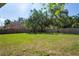 Large backyard with mature trees, offering ample space for outdoor activities at 8725 N Boulevard, Tampa, FL 33604