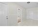 Hallway showcasing tiled floors, multiple doors, and access to different rooms within the home at 8725 N Boulevard, Tampa, FL 33604