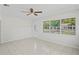Spacious living room with neutral walls, tiled flooring, and a large window offering ample natural light at 8725 N Boulevard, Tampa, FL 33604