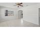 Bright living room showcasing tiled floors, a ceiling fan, and a decorative archway leading to other spaces at 8725 N Boulevard, Tampa, FL 33604