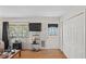 A cozy living room featuring a window, an exterior door, and closet space at 9222 Century Dr, Spring Hill, FL 34606