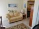Comfortable living room with a sofa and view into the kitchen at 10034 64Th N Ave # 11, St Petersburg, FL 33708