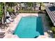 Community pool with plenty of lounge chairs and tables at 10240 Bayou Grande Ave, Seminole, FL 33772