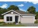 Charming single-story home with a two-car garage and landscaped front yard at 10636 Crescent Creek Xing, Parrish, FL 34219