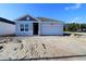 Charming single-story home featuring a one-car garage and classic architecture under a bright blue sky at 10636 Crescent Creek Xing, Parrish, FL 34219
