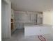 Spacious kitchen with modern white cabinetry, countertops, and a large island at 10636 Crescent Creek Xing, Parrish, FL 34219