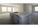 Kitchen island with white cabinets, granite countertops, and an undermount sink at 10636 Crescent Creek Xing, Parrish, FL 34219
