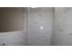 Shower featuring white marble tile surround at 10636 Crescent Creek Xing, Parrish, FL 34219