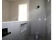 Modern bathroom featuring gray tiling, a built-in niche, and a sleek shower head at 10644 Crescent Creek Xing, Parrish, FL 34219