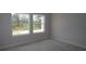 Empty bedroom with 2 windows and baseboards ready for finishing and painting at 10644 Crescent Creek Xing, Parrish, FL 34219