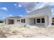 New construction home featuring a covered patio, white exterior, and spacious backyard with landscaping potential at 10644 Crescent Creek Xing, Parrish, FL 34219