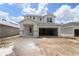 Two-story home featuring a light gray exterior, attached two-car garage, and covered entryway at 10644 Crescent Creek Xing, Parrish, FL 34219