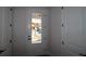 View of the house exterior through the front door with sidelight and black hardware at 10644 Crescent Creek Xing, Parrish, FL 34219