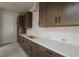 Elegant kitchen design showcasing long white countertops and stylish wood cabinets at 10644 Crescent Creek Xing, Parrish, FL 34219