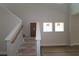 Staircase with white stringers and natural wood handrail ready for finishing at 10644 Crescent Creek Xing, Parrish, FL 34219