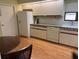 Well-lit kitchen with white cabinets and ample counter space at 11609 Parkview Ln # 53, Seminole, FL 33772