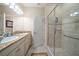 Bathroom with double sinks, granite countertops, and a glass-enclosed shower at 13208 San Blas Loop, Largo, FL 33774
