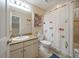 Bathroom featuring a vanity, shower-tub combination, and decorative accents at 13208 San Blas Loop, Largo, FL 33774