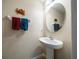 Bathroom featuring a pedestal sink, decorative wall art, and warm-toned walls at 13208 San Blas Loop, Largo, FL 33774