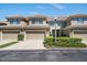 Charming multi-Gathering home featuring well-maintained landscaping, garages, and a warm, inviting facade at 13208 San Blas Loop, Largo, FL 33774