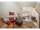 Open-concept living room with high ceilings, natural light, and seamless flow to dining and kitchen areas at 13208 San Blas Loop, Largo, FL 33774