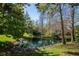 Scenic backyard view of a tranquil pond surrounded by lush greenery and mature trees at 13208 San Blas Loop, Largo, FL 33774