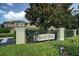 Community entrance featuring the Beacon Trace sign, mature trees and well-maintained landscaping at 13208 San Blas Loop, Largo, FL 33774