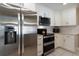 Close up of updated kitchen with stainless steel appliances, and white cabinets at 13524 91St Ave, Seminole, FL 33776