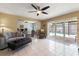 Open living room with tile floors, fireplace, access to outside, and open concept to kitchen at 13524 91St Ave, Seminole, FL 33776