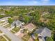 Aerial view of a neighborhood with lush landscaping and mature trees at 13526 Norman Cir, Hudson, FL 34669