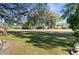 Expansive backyard featuring green grass, trees, and landscaping at 13526 Norman Cir, Hudson, FL 34669