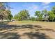 Expansive backyard featuring green grass and trees at 13526 Norman Cir, Hudson, FL 34669