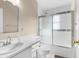 Bathroom featuring a shower with glass doors, vanity, and toilet at 13526 Norman Cir, Hudson, FL 34669