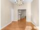 Open dining room with wood floors and a view of the kitchen's barstool seating at 13526 Norman Cir, Hudson, FL 34669