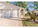 Home with a two-car garage, walkway to the front door, and well-maintained landscaping at 13526 Norman Cir, Hudson, FL 34669