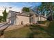 Single-story home with a two-car garage, lush landscaping, and exterior lighting at 13526 Norman Cir, Hudson, FL 34669