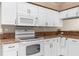 Close up of the white oven and granite counter tops at 13526 Norman Cir, Hudson, FL 34669
