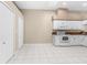 Bright kitchen with white cabinets, tile floors, and modern appliances at 13526 Norman Cir, Hudson, FL 34669