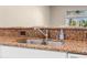 A double sink featuring brown granite counter tops at 13526 Norman Cir, Hudson, FL 34669