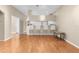 Hardwood floor living room featuring kitchen bar with chairs at 13526 Norman Cir, Hudson, FL 34669