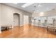Open-concept living room with hardwood floors and kitchen bar with chairs at 13526 Norman Cir, Hudson, FL 34669