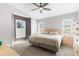 Main bedroom with a ceiling fan and bright windows at 13526 Norman Cir, Hudson, FL 34669