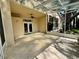 Tiled patio with a ceiling fan, leading to a landscaped yard, perfect for relaxing and enjoying the outdoors at 13526 Norman Cir, Hudson, FL 34669