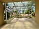 Enclosed tiled patio offering a serene outdoor living space with views of the surrounding landscaping and greenery at 13526 Norman Cir, Hudson, FL 34669