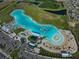Aerial view of the community's turquoise-colored lagoon featuring sandy beaches, lounge chairs, and water activities at 17152 Scuba Crest St, Wimauma, FL 33598