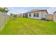 Expansive backyard with lush green lawn, perfect for outdoor activities and entertaining guests at 17152 Scuba Crest St, Wimauma, FL 33598