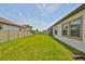 Spacious backyard with lush green grass and well-maintained landscaping, offering privacy and tranquility at 17152 Scuba Crest St, Wimauma, FL 33598